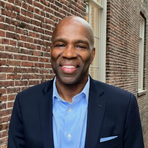 Professional headshot of James Runcie in business attire