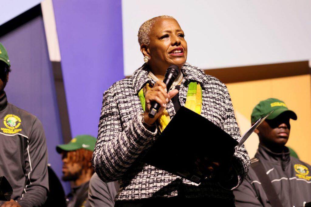 Speaker presenting at HBCU event with microphone